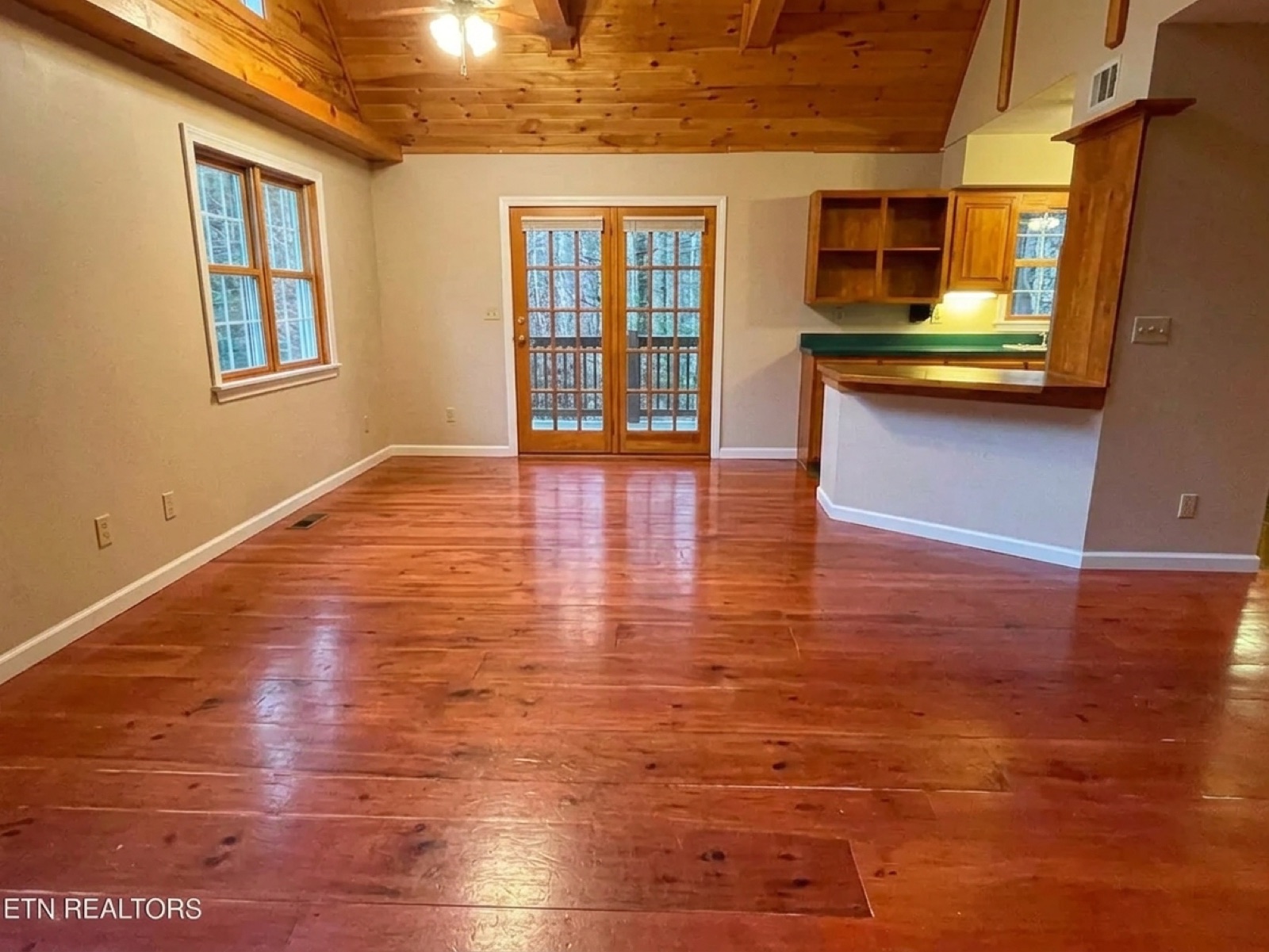 Cabin great room and kitchen with oversized sectional — after unstaging