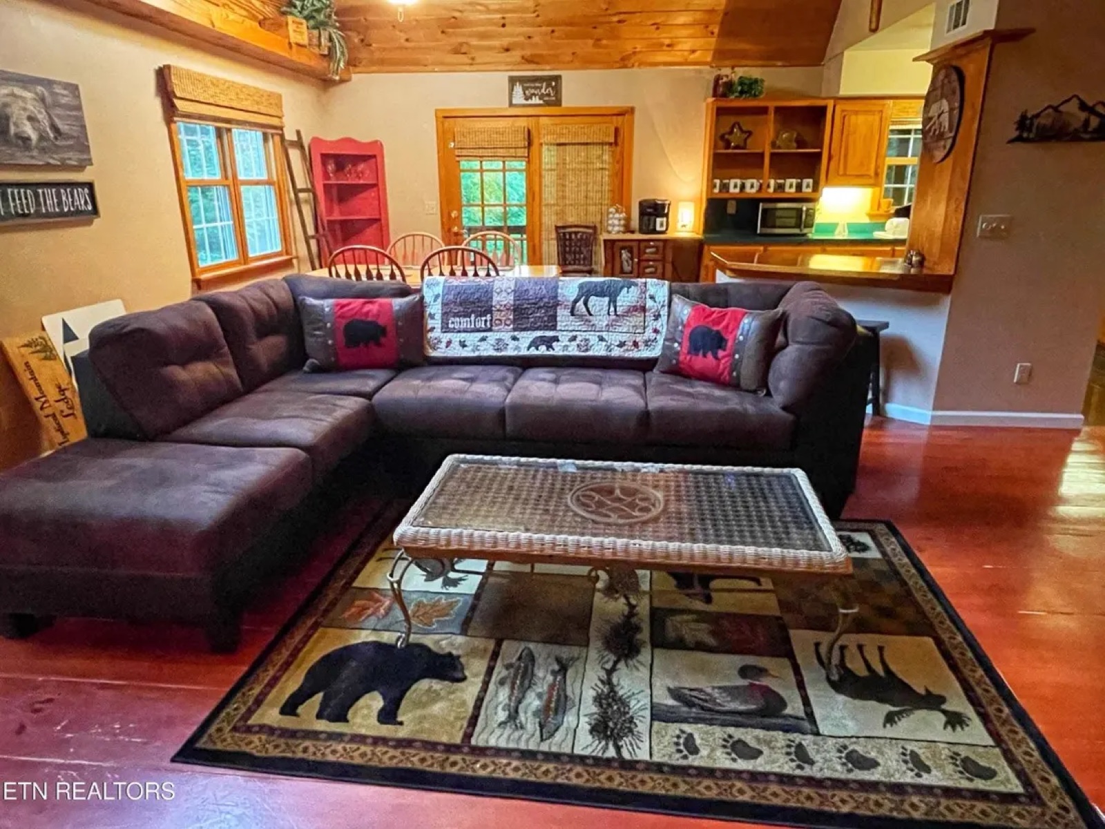 Cabin great room and kitchen with oversized sectional — before